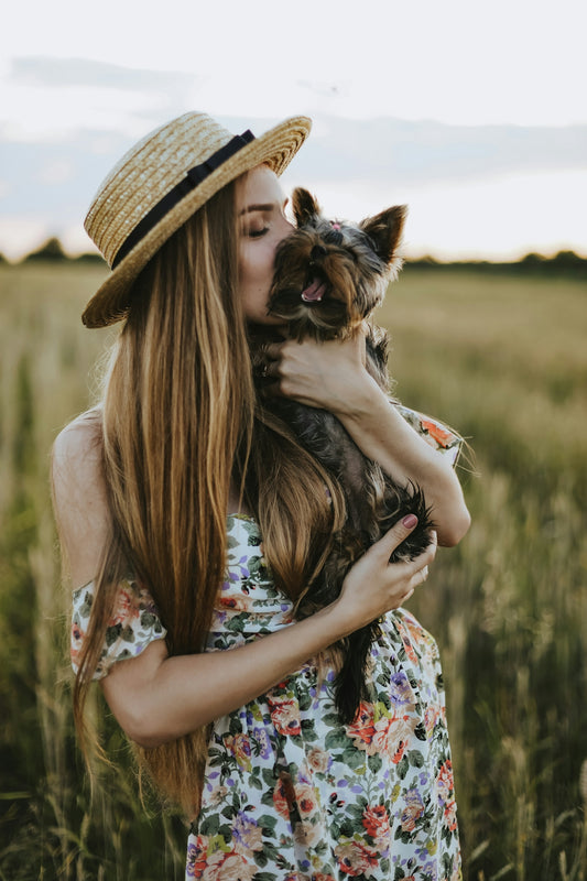 a woman holding a dog